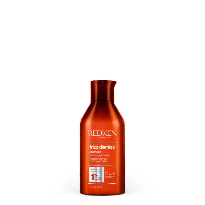 Redken Frizz Dismiss Shampoo with anti-humidity protection in an orange bottle.